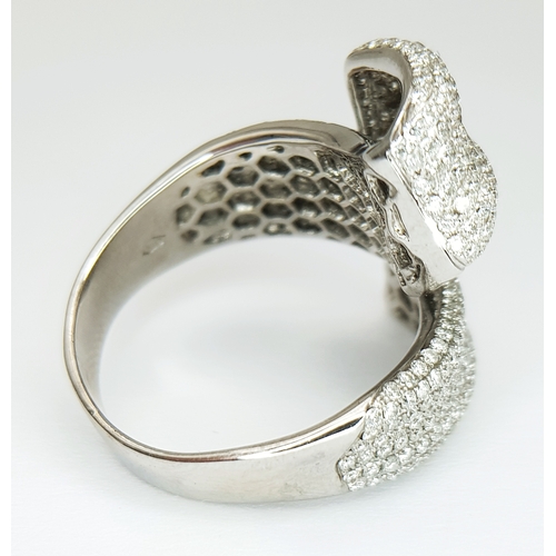 29 - An 18K White Gold Diamond Statement Ring. Abstract crossover form with c.4ctw of round brilliant cut... 