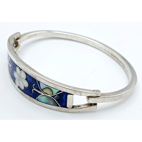 176 - A Mexico Silver Bangle with Blue Enamel and Mother of Pearl Floral Decoration. Approx 5.5cm diameter... 