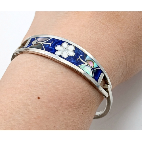 176 - A Mexico Silver Bangle with Blue Enamel and Mother of Pearl Floral Decoration. Approx 5.5cm diameter... 