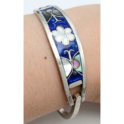 176 - A Mexico Silver Bangle with Blue Enamel and Mother of Pearl Floral Decoration. Approx 5.5cm diameter... 