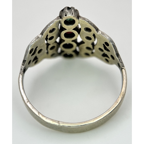 122 - An Antique Gold, Silver, Ruby and Emerald Ring. The band tests as 14k gold with an openwork silver s... 
