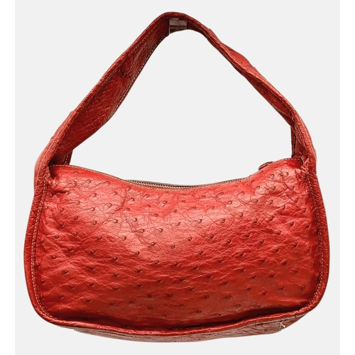 124 - A Red Prada Ostrich Effect Leather Crossbody Bag. Red ostrich effect leather exterior with silver-to... 