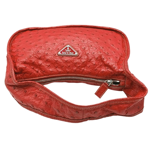 124 - A Red Prada Ostrich Effect Leather Crossbody Bag. Red ostrich effect leather exterior with silver-to... 