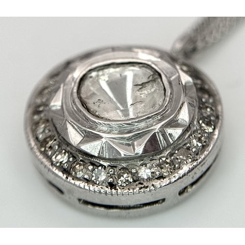 137 - A Platinum 0.5ct Centre Diamond Halo Pendant on a 9K White Gold Chain Necklace. The Centre Diamond o... 