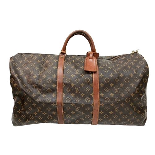 138 - A Brown Louis Vuitton Monogram Keepall 60 Travel Bag. Brown monogram coated canvas exterior with vac... 