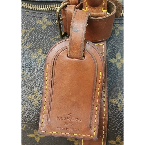138 - A Brown Louis Vuitton Monogram Keepall 60 Travel Bag. Brown monogram coated canvas exterior with vac... 