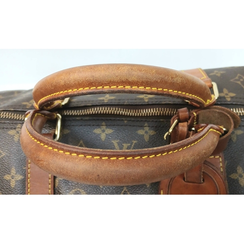 138 - A Brown Louis Vuitton Monogram Keepall 60 Travel Bag. Brown monogram coated canvas exterior with vac... 