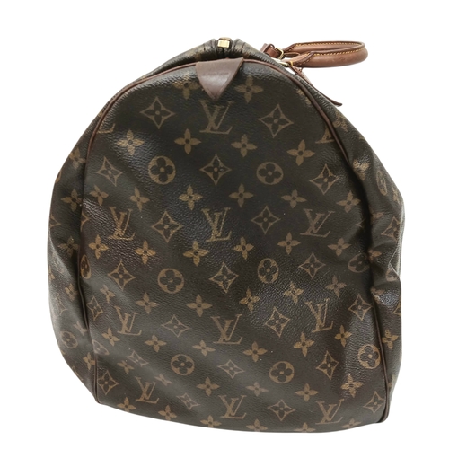 138 - A Brown Louis Vuitton Monogram Keepall 60 Travel Bag. Brown monogram coated canvas exterior with vac... 