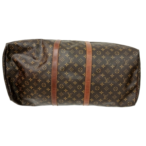 138 - A Brown Louis Vuitton Monogram Keepall 60 Travel Bag. Brown monogram coated canvas exterior with vac... 