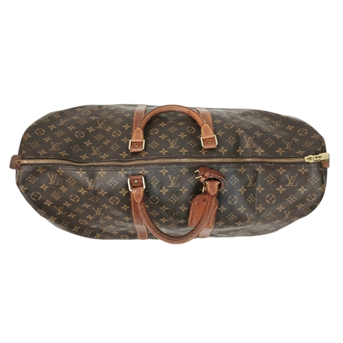 138 - A Brown Louis Vuitton Monogram Keepall 60 Travel Bag. Brown monogram coated canvas exterior with vac... 
