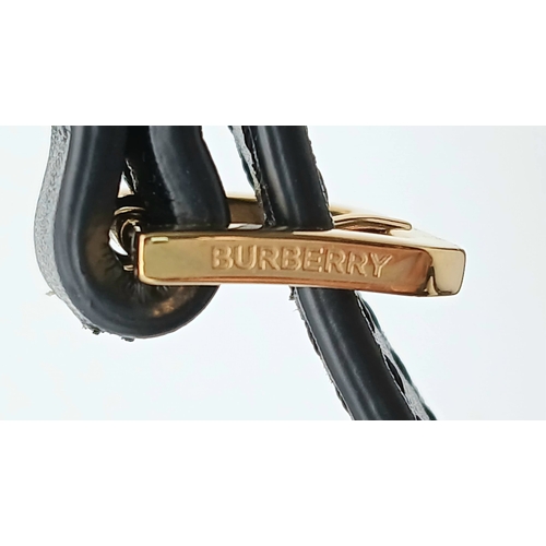 159 - A Burberry Black Leather TB Crossbody Bag. Smooth black leather exterior with gold-tone hardware, ad... 