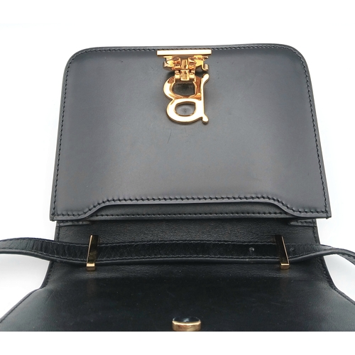 159 - A Burberry Black Leather TB Crossbody Bag. Smooth black leather exterior with gold-tone hardware, ad... 