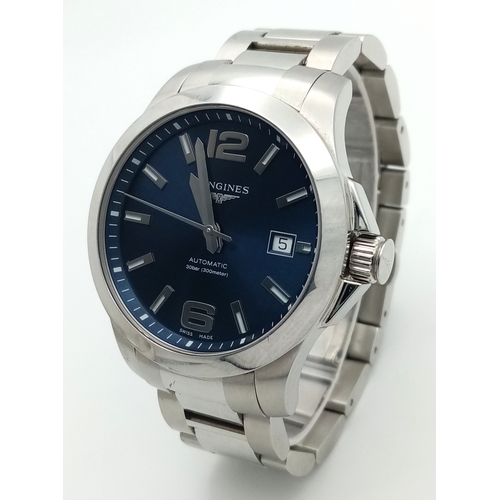 163 - A Longines Conquest Automatic Gents Watch. Stainless steel bracelet and case - 39mm. Navy blue dial ... 