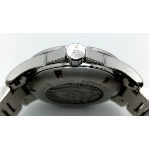 163 - A Longines Conquest Automatic Gents Watch. Stainless steel bracelet and case - 39mm. Navy blue dial ... 