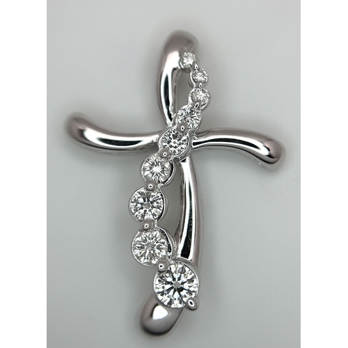 241 - A 14K White Gold Diamond Cross Pendant. c.0.60ctw of round brilliant cut diamonds having G-H colour ... 