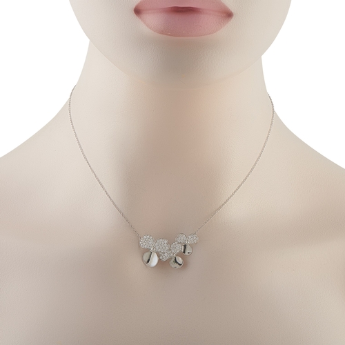 155 - A Tiffany & Co. Paper Flowers Platinum Diamond Pendant Necklace. Set in Platinum, the three-petal fl... 