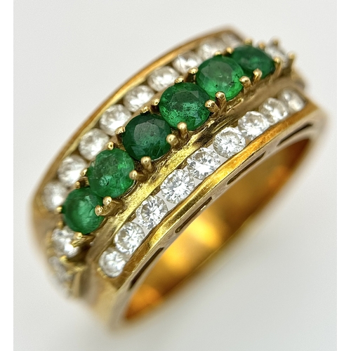 167 - An 18K Yellow Gold Emerald and Diamond Cocktail Ring. 0.30ctw of round cut emeralds between c.1ctw o... 