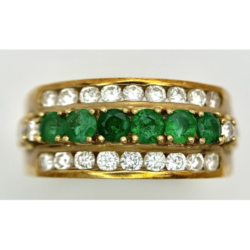 167 - An 18K Yellow Gold Emerald and Diamond Cocktail Ring. 0.30ctw of round cut emeralds between c.1ctw o... 