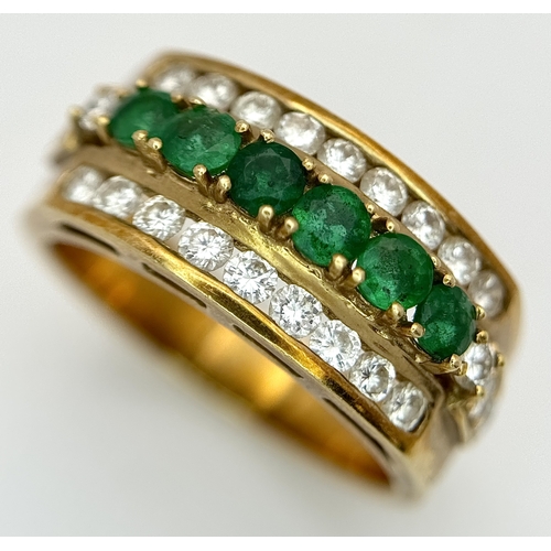 167 - An 18K Yellow Gold Emerald and Diamond Cocktail Ring. 0.30ctw of round cut emeralds between c.1ctw o... 