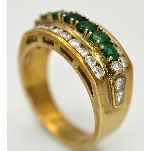 167 - An 18K Yellow Gold Emerald and Diamond Cocktail Ring. 0.30ctw of round cut emeralds between c.1ctw o... 