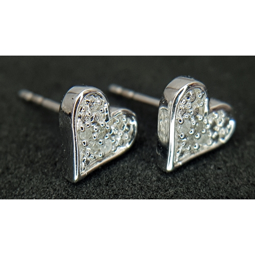 566 - A PAIR OF 9K WHITE GOLD, DIAMOND SET, HEART SHAPED STUD EARRINGS. 1.3G. NEEDS BUTTERFLY BACKS.  SC 1... 
