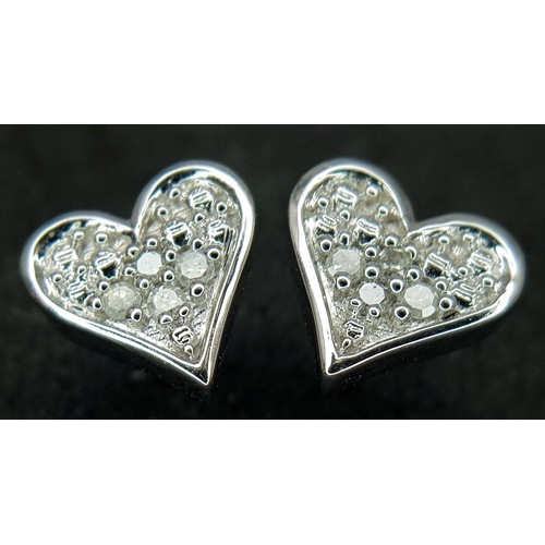 566 - A PAIR OF 9K WHITE GOLD, DIAMOND SET, HEART SHAPED STUD EARRINGS. 1.3G. NEEDS BUTTERFLY BACKS.  SC 1... 