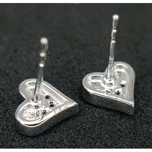 566 - A PAIR OF 9K WHITE GOLD, DIAMOND SET, HEART SHAPED STUD EARRINGS. 1.3G. NEEDS BUTTERFLY BACKS.  SC 1... 