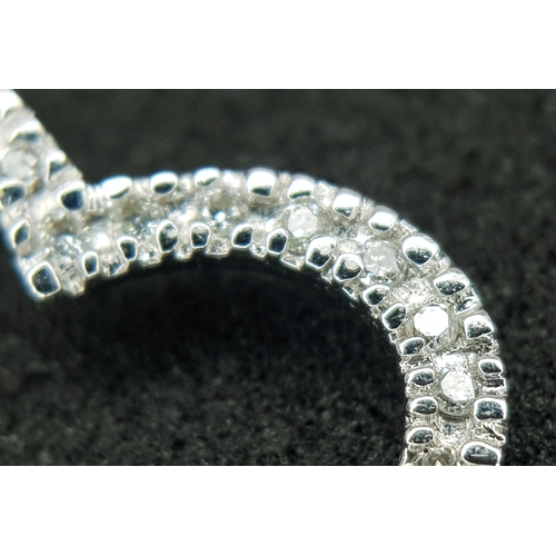 573 - A 9K WHITE GOLD, DIAMOND SET , OPEN HEART PENDANT. 1.2G. SC 1013