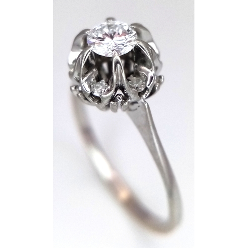 1213 - An 18K White Gold Diamond Cluster Ring. A 0.25ct round brilliant cut centre stone with a 0.20ctw dia... 