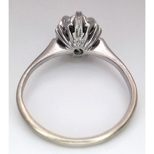 1213 - An 18K White Gold Diamond Cluster Ring. A 0.25ct round brilliant cut centre stone with a 0.20ctw dia... 