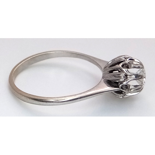 1213 - An 18K White Gold Diamond Cluster Ring. A 0.25ct round brilliant cut centre stone with a 0.20ctw dia... 