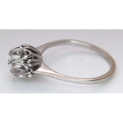 1213 - An 18K White Gold Diamond Cluster Ring. A 0.25ct round brilliant cut centre stone with a 0.20ctw dia... 