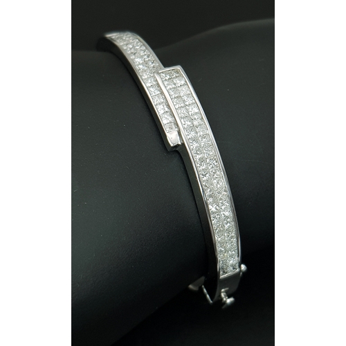 32 - A Sophisticated 18K White Gold and Diamond Crossover Bangle Bracelet. Eighty-Four Princess cut chann... 