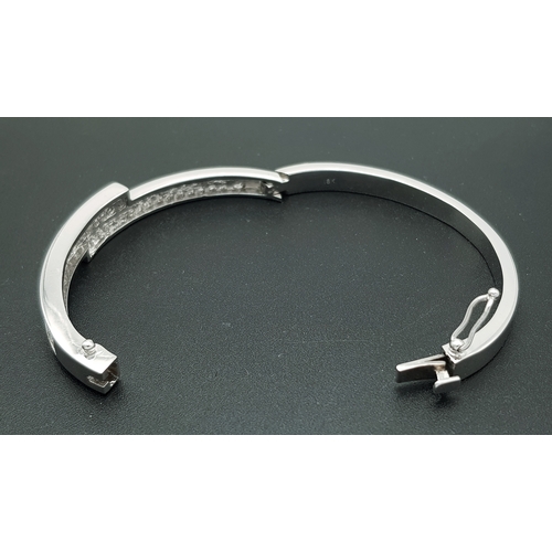 32 - A Sophisticated 18K White Gold and Diamond Crossover Bangle Bracelet. Eighty-Four Princess cut chann... 