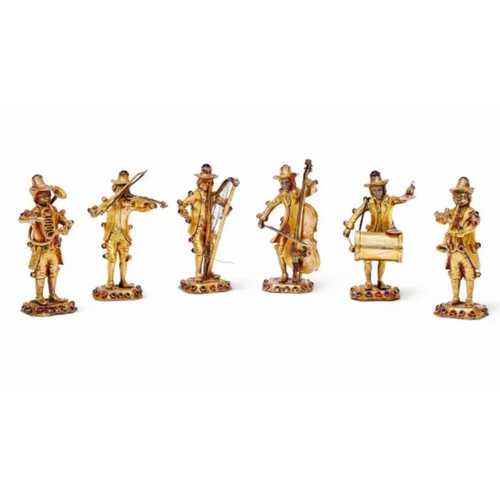 An Antique German Set of Six Gilded Silver and Stone Set Musician Figures. Circa 1880. Each figure plays a different instrument. Raised on a canted rectangular base, set with various gemstone cabochons. Hallmarked 'SILVER'. 11cm tall. 705g total weight.