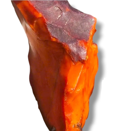 A large piece of natural amber with an exceptionally rare deep red ...