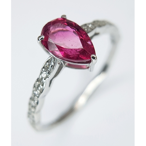 555 - A 950 PLATINUM, 1.12ctw Brazilian Pink Tourmaline Ring with Diamond Accents. A 1.03ct pear mixed cut... 