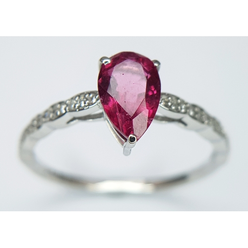 555 - A 950 PLATINUM, 1.12ctw Brazilian Pink Tourmaline Ring with Diamond Accents. A 1.03ct pear mixed cut... 