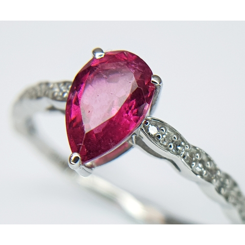 555 - A 950 PLATINUM, 1.12ctw Brazilian Pink Tourmaline Ring with Diamond Accents. A 1.03ct pear mixed cut... 