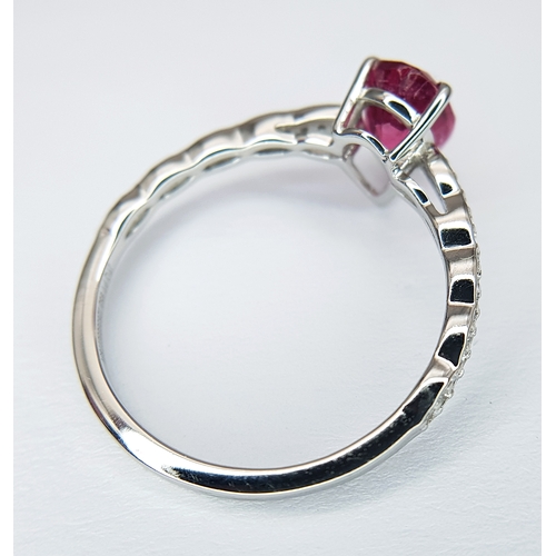 555 - A 950 PLATINUM, 1.12ctw Brazilian Pink Tourmaline Ring with Diamond Accents. A 1.03ct pear mixed cut... 