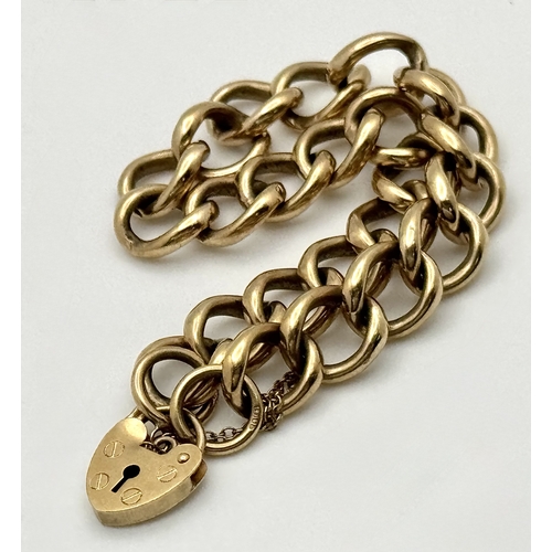 15 - A Vintage 9K Yellow Gold Curb Link Bracelet with Heart Clasp and safety chain. 18cm. 16.57cm.