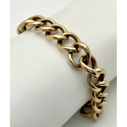 15 - A Vintage 9K Yellow Gold Curb Link Bracelet with Heart Clasp and safety chain. 18cm. 16.57cm.