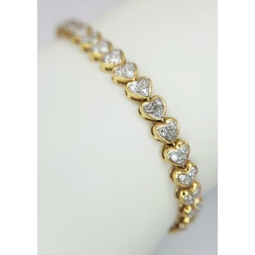 11 - An 18K Yellow Gold Diamond Tennis Bracelet in Heart-Shaped Links. Over 100 round brilliant cut diamo... 