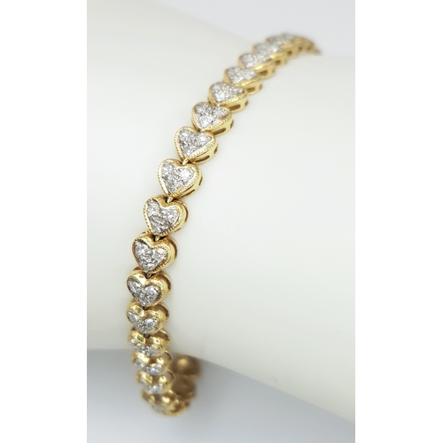 11 - An 18K Yellow Gold Diamond Tennis Bracelet in Heart-Shaped Links. Over 100 round brilliant cut diamo... 