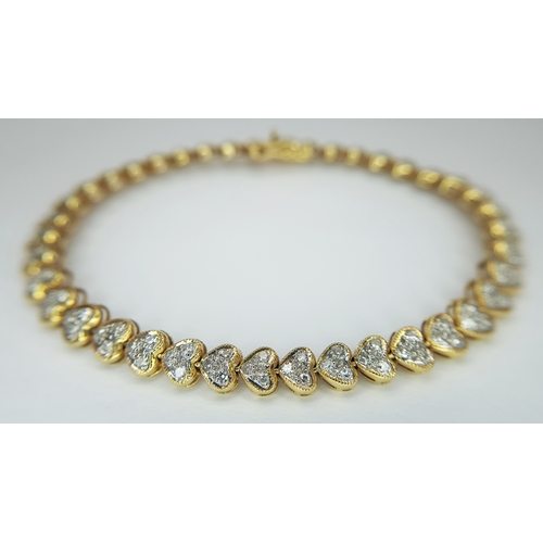 11 - An 18K Yellow Gold Diamond Tennis Bracelet in Heart-Shaped Links. Over 100 round brilliant cut diamo... 