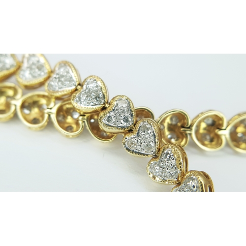 11 - An 18K Yellow Gold Diamond Tennis Bracelet in Heart-Shaped Links. Over 100 round brilliant cut diamo... 