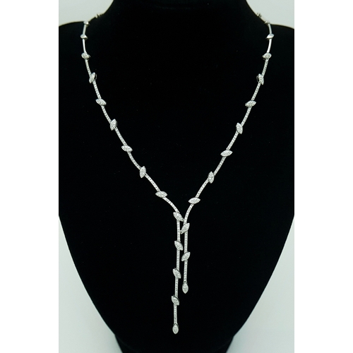 An 18K White Gold and Diamond Y-Drop Necklace Featuring a Continuous String of Leaf-Shaped Motifs. Two thirds of the necklace being diamond encrusted with c. 2.8ctw of round brilliant cut diamonds. 44cm necklace length. 7cm drop. 22.8g total weight. MT35.