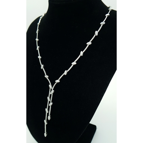 78 - An 18K White Gold and Diamond Y-Drop Necklace Featuring a Continuous String of Leaf-Shaped Motifs. T... 