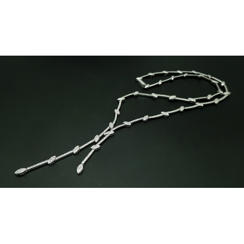 78 - An 18K White Gold and Diamond Y-Drop Necklace Featuring a Continuous String of Leaf-Shaped Motifs. T... 