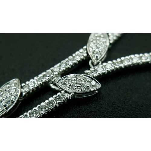 78 - An 18K White Gold and Diamond Y-Drop Necklace Featuring a Continuous String of Leaf-Shaped Motifs. T... 